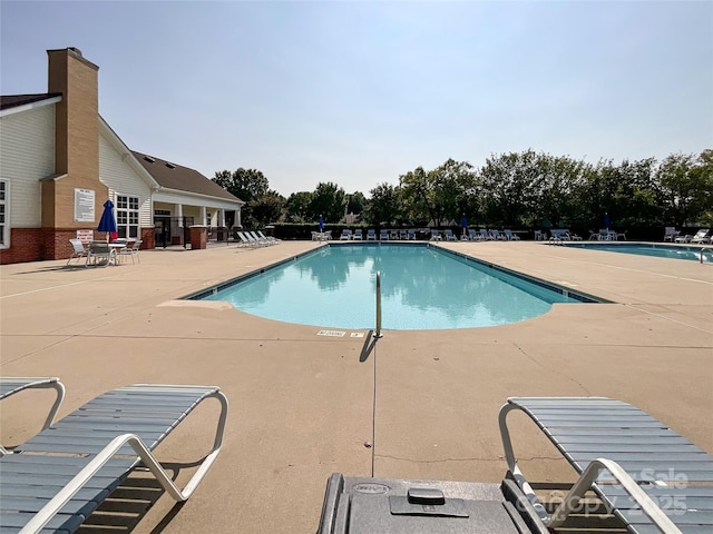 view of swimming pool with a patio