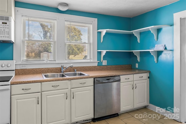 kitchen with white cabinetry, white appliances, sink, and light tile patterned floors