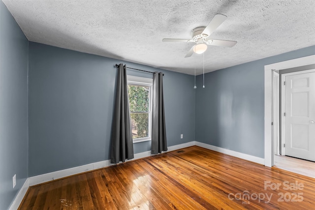 unfurnished room featuring wood-type flooring, a textured ceiling, and ceiling fan