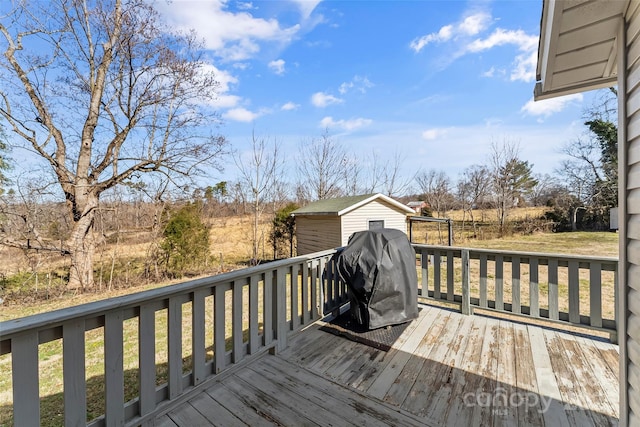 wooden deck with grilling area and a storage shed