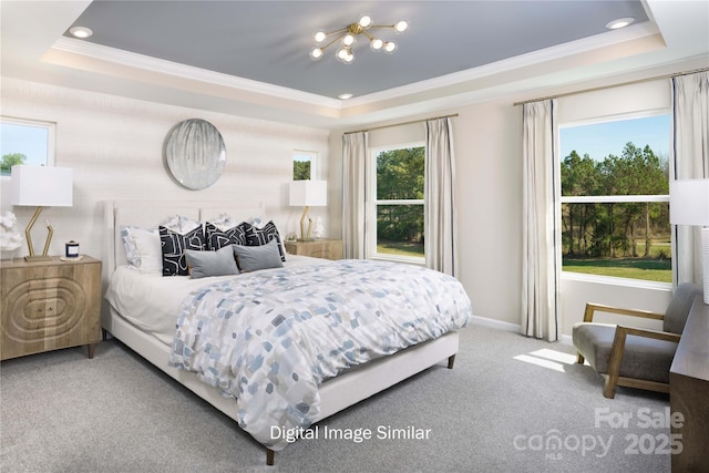 carpeted bedroom with a raised ceiling and ornamental molding