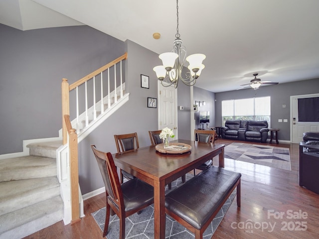 dining space with wood-type flooring and ceiling fan with notable chandelier