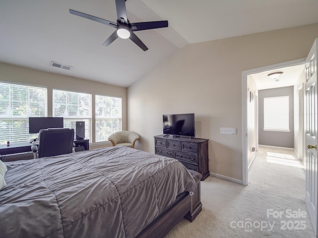 bedroom featuring lofted ceiling, light colored carpet, and ceiling fan