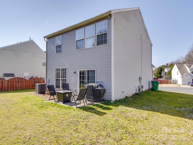 back of property with a lawn, a patio, and central air condition unit