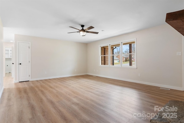 unfurnished room with ceiling fan and light wood-type flooring