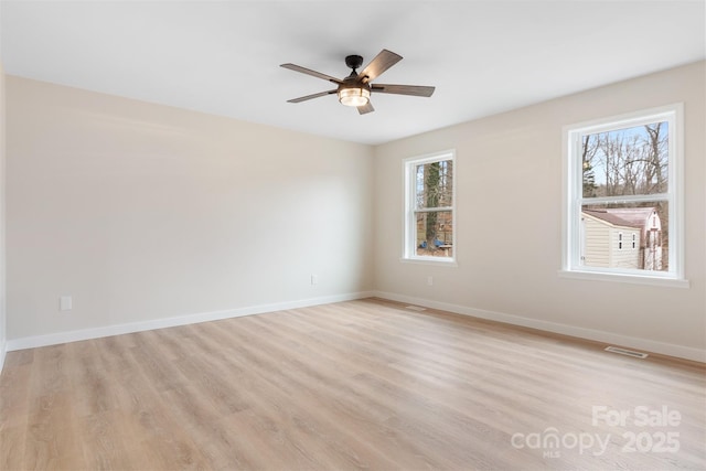 empty room featuring ceiling fan and light hardwood / wood-style floors