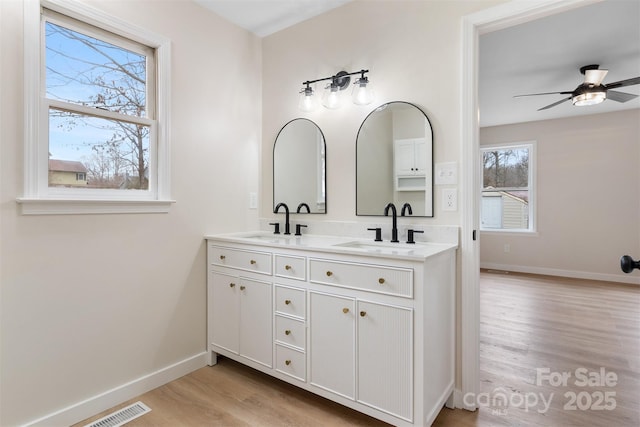 bathroom featuring vanity, hardwood / wood-style floors, and ceiling fan