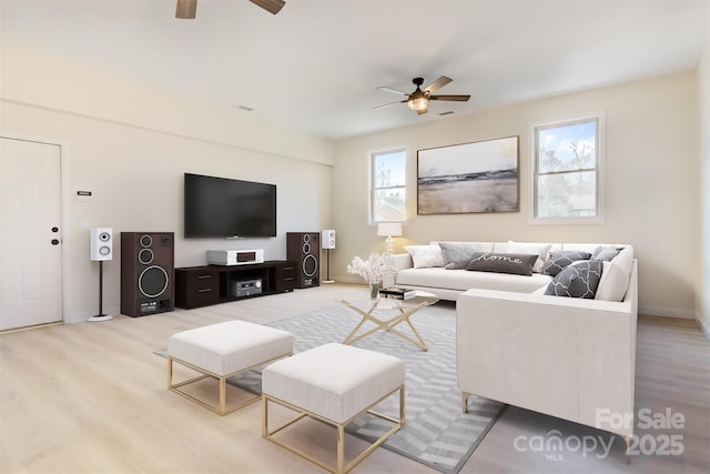 living room featuring ceiling fan and light wood-type flooring