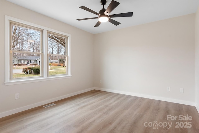 spare room featuring light hardwood / wood-style flooring and ceiling fan