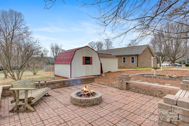 view of patio featuring a shed and a fire pit