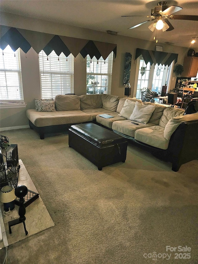 carpeted living room featuring ceiling fan