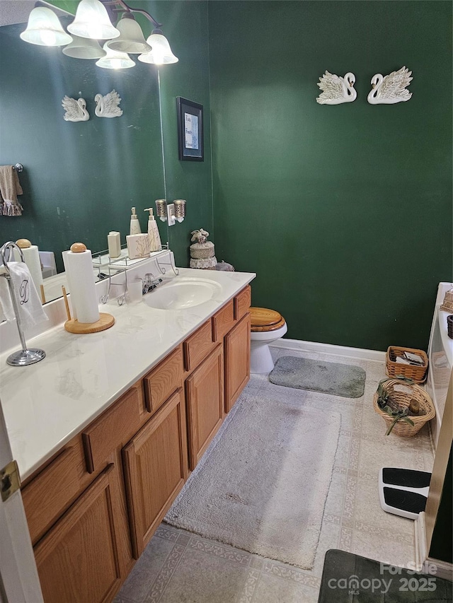 bathroom with tile patterned flooring, vanity, and toilet