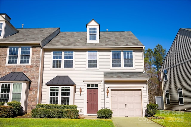 view of front of property with a garage and a front yard