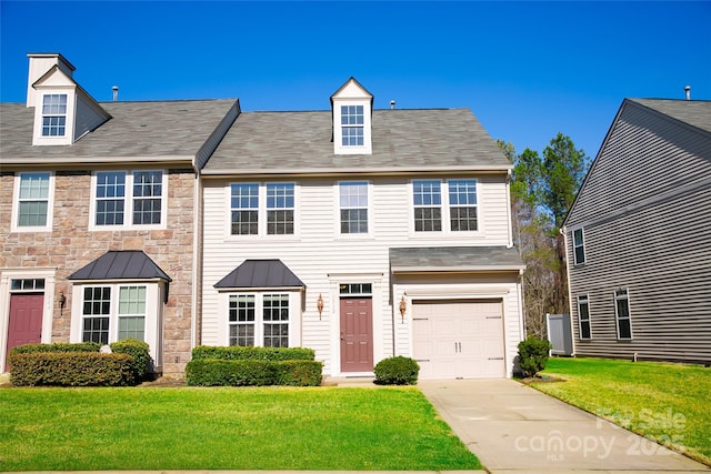 view of front of property featuring a garage and a front lawn