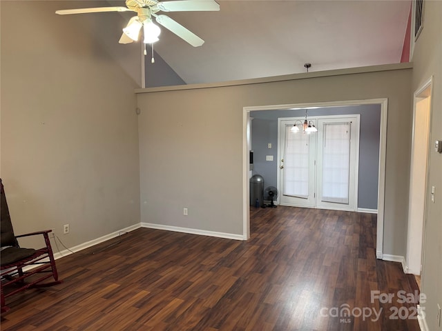 entrance foyer with dark wood-type flooring, vaulted ceiling, and ceiling fan with notable chandelier