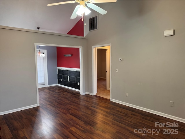 unfurnished living room with ceiling fan, dark hardwood / wood-style floors, and high vaulted ceiling