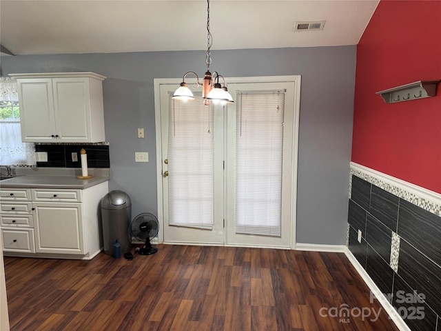 entryway with a notable chandelier and dark hardwood / wood-style floors