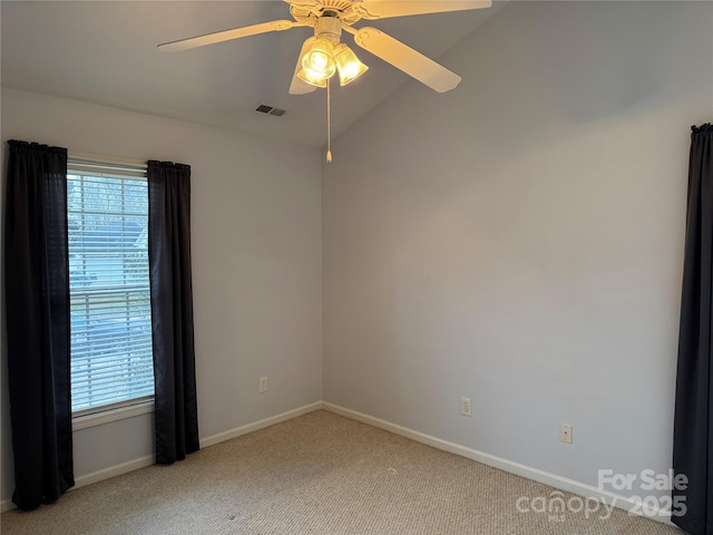 carpeted empty room featuring lofted ceiling and ceiling fan