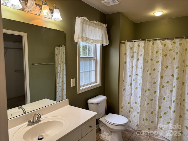 bathroom featuring vanity, toilet, and a shower with shower curtain