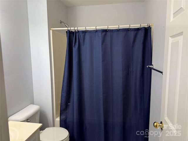 full bathroom with vanity, shower / bath combo with shower curtain, and toilet