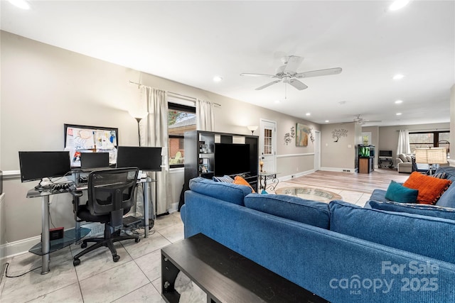 tiled living room with ceiling fan