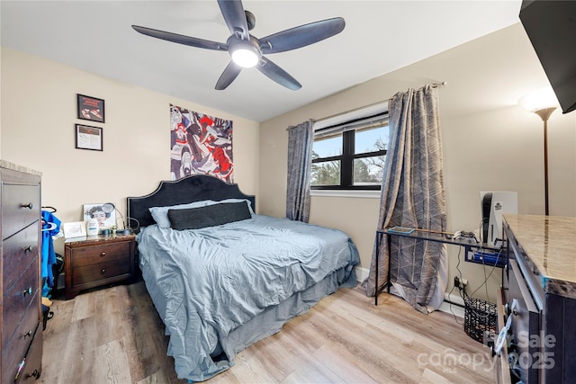 bedroom with ceiling fan and light hardwood / wood-style flooring