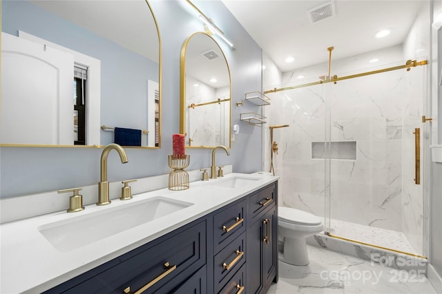 bathroom featuring an enclosed shower, vanity, and toilet