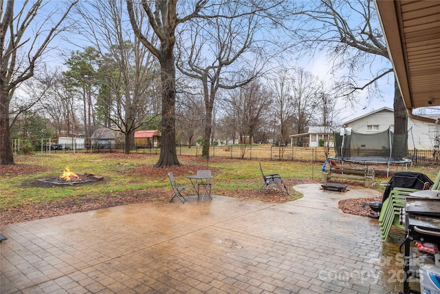 view of patio featuring a fire pit and a trampoline