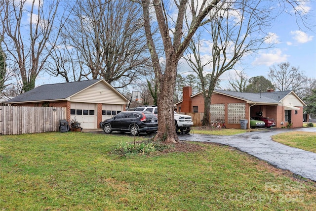 view of side of property featuring a garage and a lawn