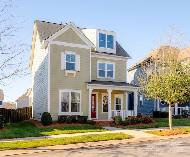 view of front of house with a porch and a front lawn