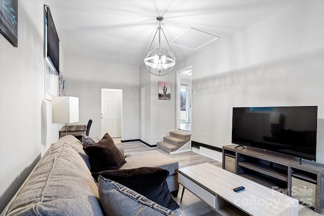 living room featuring a chandelier and light hardwood / wood-style flooring