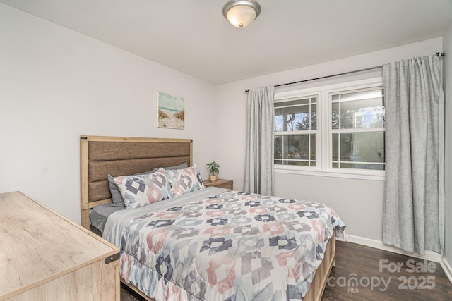 bedroom with dark wood-type flooring