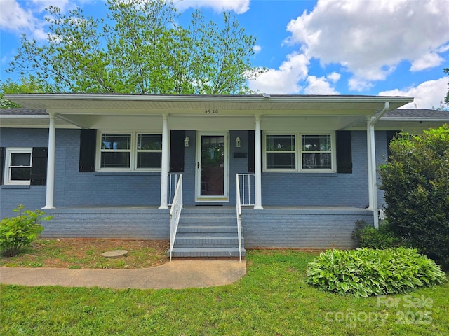 4930 Crestmont Dr, Charlotte, NC 28205 - view of front of property featuring brick siding, a porch, and a front yard