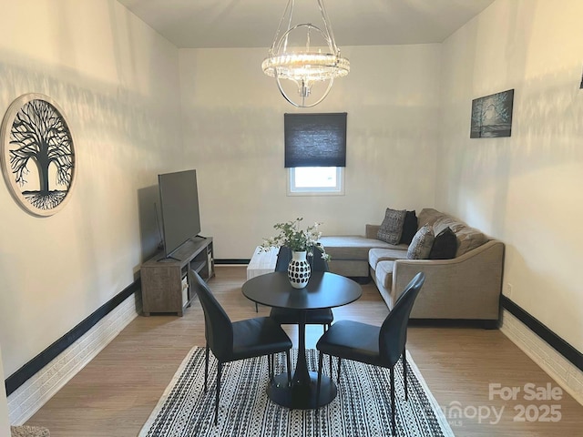 4930 Crestmont Dr, Charlotte, NC 28205 - dining space featuring a chandelier, baseboards, and light wood-type flooring