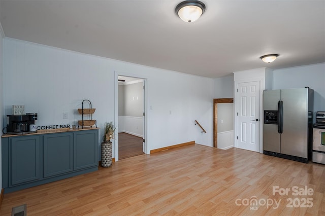 kitchen with stainless steel appliances, visible vents, and light wood-style floors