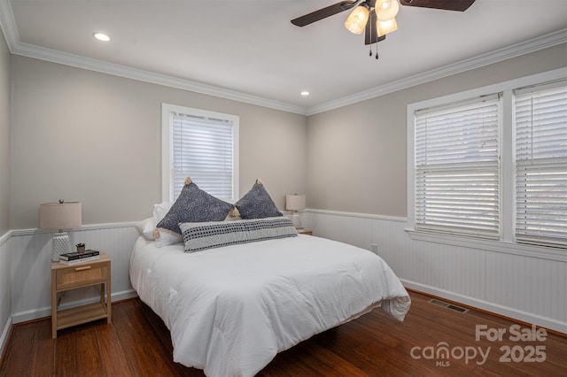 bedroom with visible vents, a wainscoted wall, ornamental molding, wood finished floors, and recessed lighting