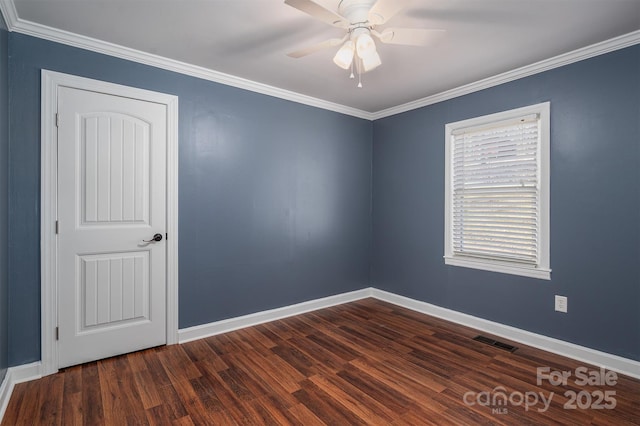 unfurnished room featuring visible vents, dark wood finished floors, baseboards, ceiling fan, and crown molding