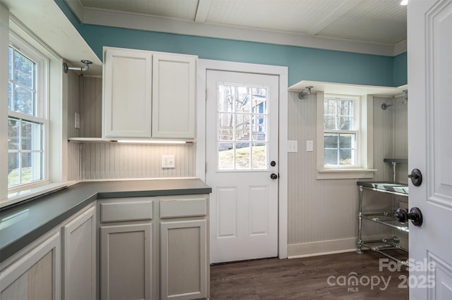 interior space with dark wood finished floors and baseboards