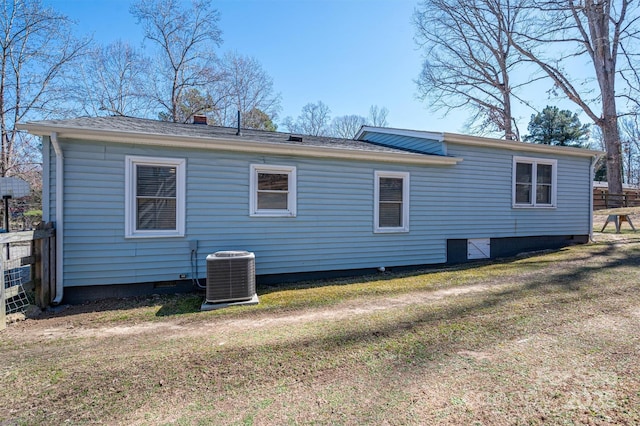 rear view of property with a chimney, crawl space, fence, a yard, and central AC