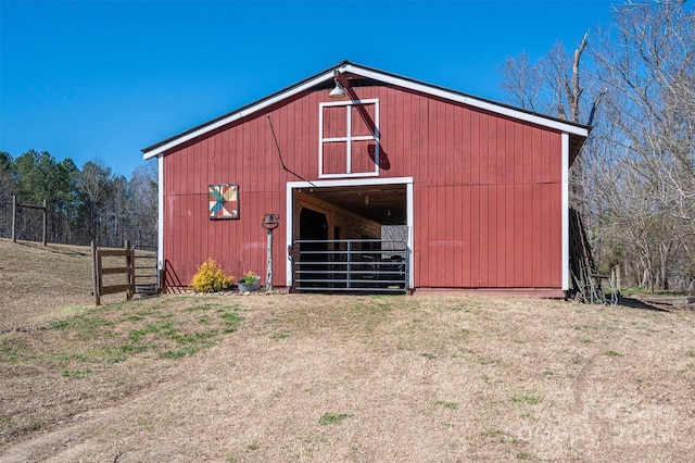 view of barn with fence