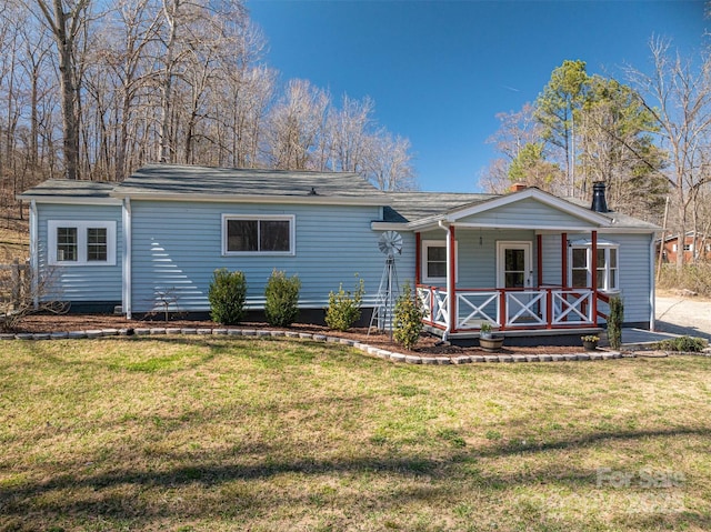 view of front of property with a porch and a front yard