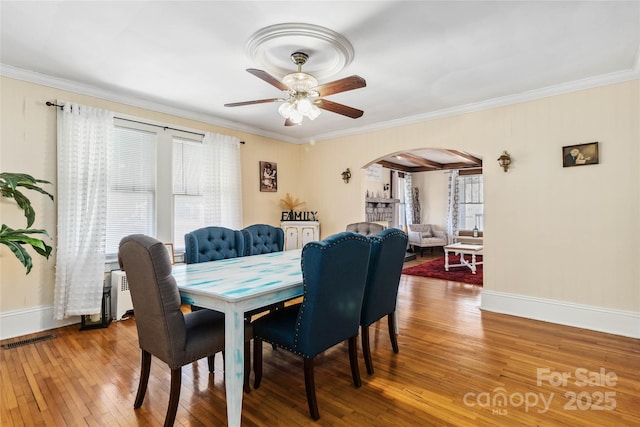 dining space featuring crown molding, ceiling fan, and hardwood / wood-style floors