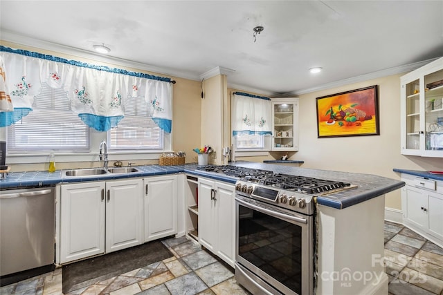 kitchen with sink, white cabinetry, crown molding, appliances with stainless steel finishes, and kitchen peninsula