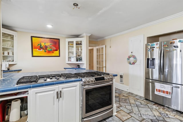 kitchen featuring stainless steel refrigerator with ice dispenser, white cabinetry, ornamental molding, and tile counters