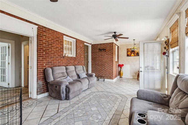 tiled living room with crown molding, brick wall, and ceiling fan