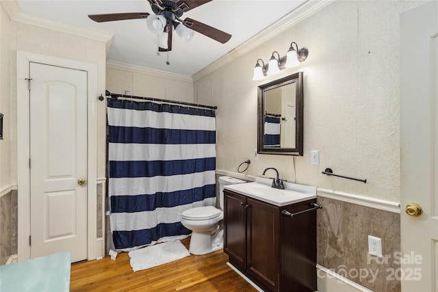 bathroom with crown molding, vanity, toilet, and hardwood / wood-style flooring