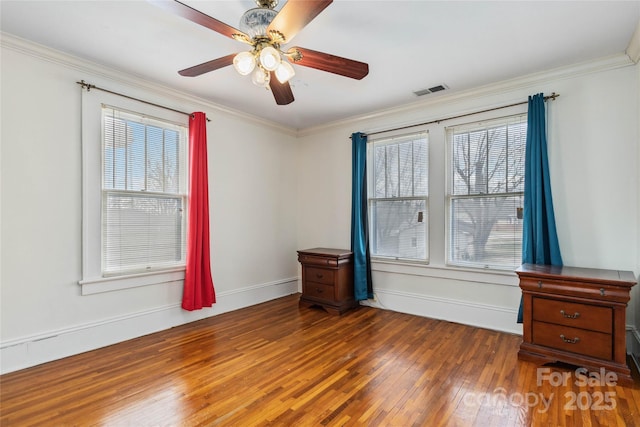 spare room with ceiling fan, ornamental molding, and dark hardwood / wood-style flooring