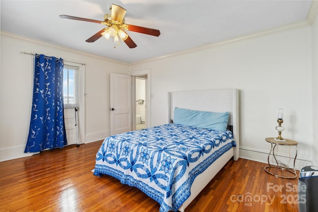 bedroom with ornamental molding and dark hardwood / wood-style flooring