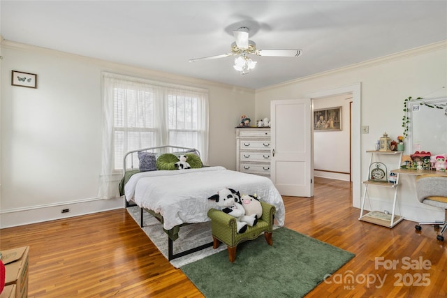 bedroom with wood-type flooring, ceiling fan, and crown molding