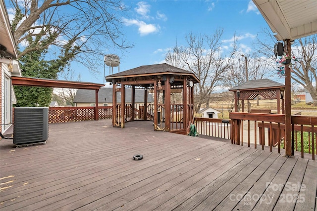 wooden deck with a gazebo and cooling unit